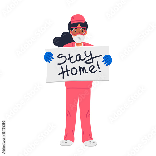 Young nurse in pink scrubs holding sign with stay home inscription