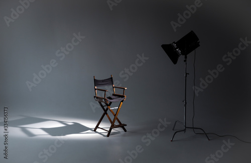 Empty photo studio with lighting equipment. Space for text. Vacant directors chair. The concept of selection and casting. Job recruitment advertisement. photo