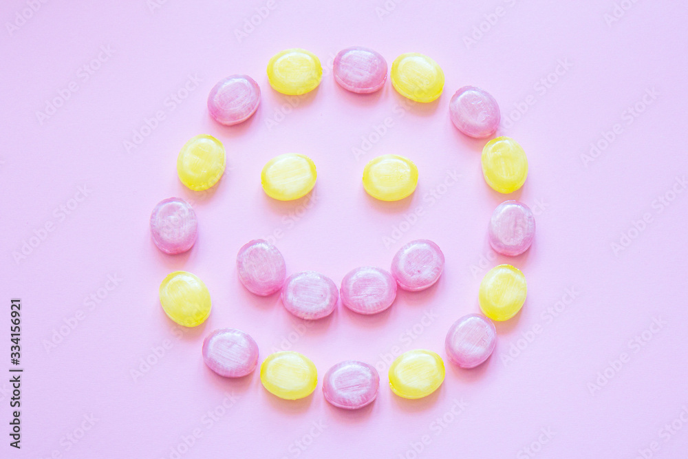 Multicolored candy on a colored background. Flat lay