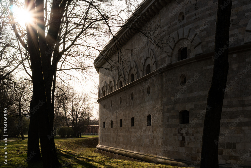 Fototapeta premium White big brick wall with a tree in front