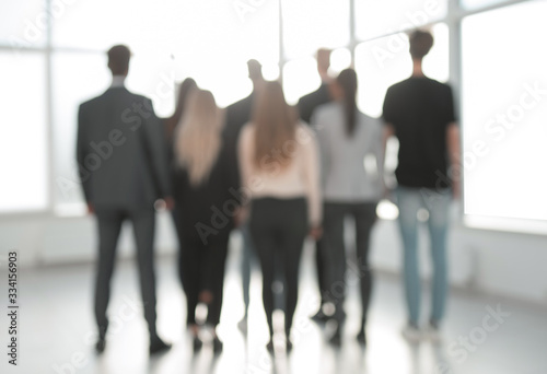background image of a group of business people standing in the office