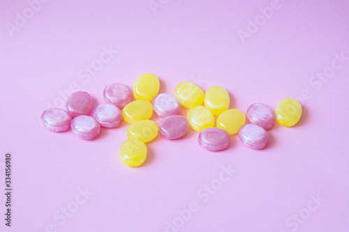 Multicolored candy on a colored background. Flat lay