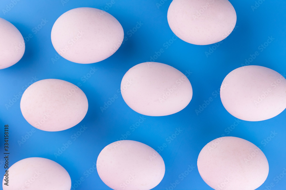 White eggs on a blue background. Background of eggs. White eggs on a blue background. Background of eggs.