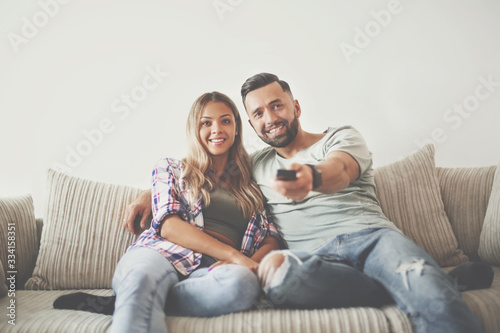 Young couple enjoying themselves on the sofa in the living room