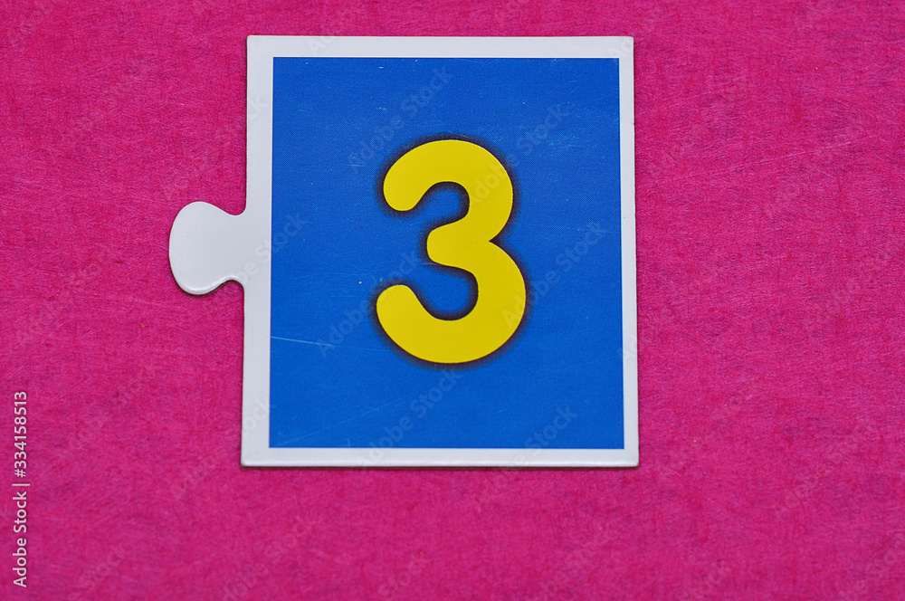 A jigsaw piece with the figure three A jigsaw piece with the figure three