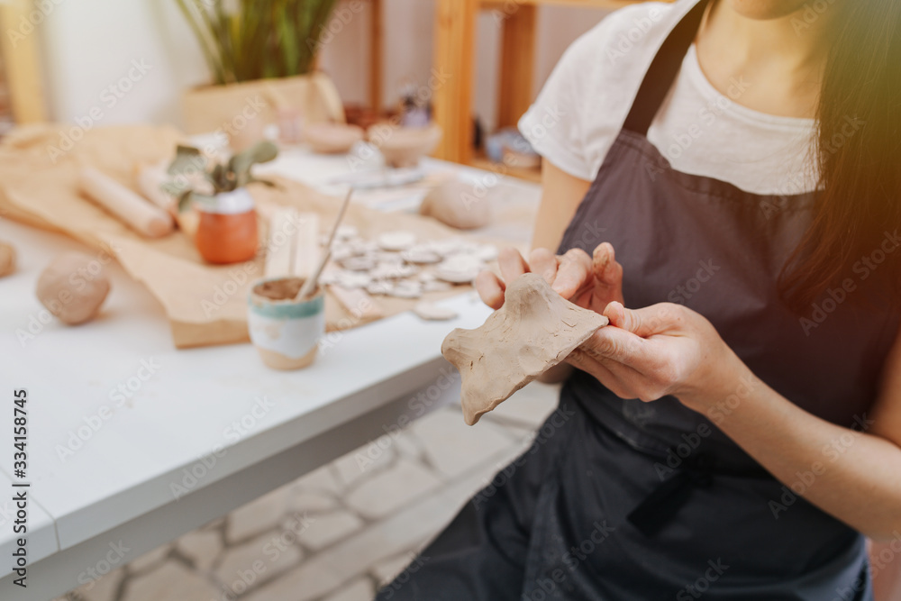 Close-up of women's hands, she sculpts from clay