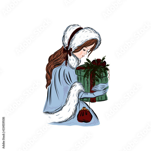 Girl dressed in warm winter cape and fur hat holds Christmas gift. 