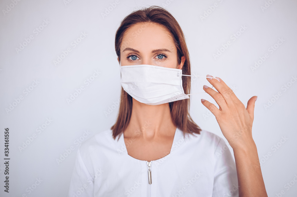 Close up portrait of beautiful young european woman doctor nurse wearing protective mask corona virus prevention. Free space for text mockup banner. Avoid contaminating Corona virus Covid-19 concept Close up portrait of beautiful young european woman doctor nurse wearing protective mask corona virus prevention. Free space for text mockup banner. Avoid contaminating Corona virus Covid-19 concept