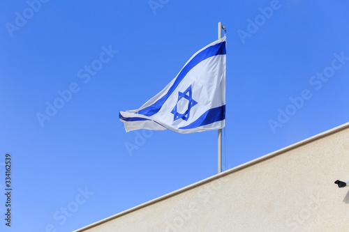 Flag of Israel ower a wall