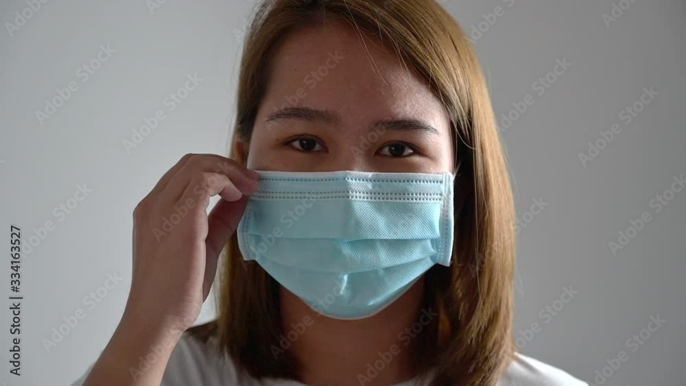 Asian young woman pastry shop owner wearing a hygiene protective mask over her face on White background,Coronavirus Covid-19 and Air pollution pm2.5 concept background. Asian young woman pastry shop owner wearing a hygiene protective mask over her face on White background,Coronavirus Covid-19 and Air pollution pm2.5 concept background.