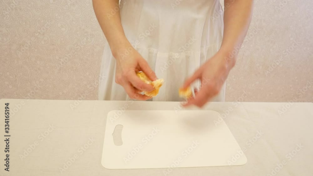 The girl divides into slices of tangerine. The girl divides into slices of tangerine.
