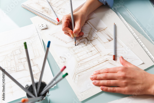 Interior designer drawing pencil illustration of a living room photo