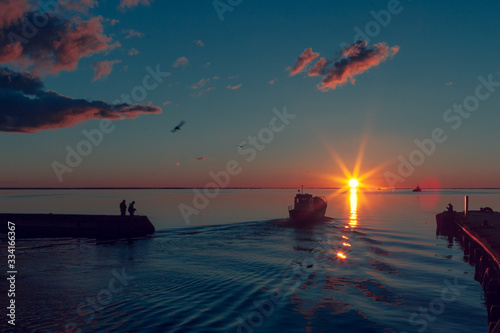 Fishing boat goes to sea at dawn.