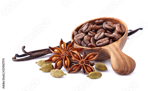 Coffee beans with cardamom, vanilla  and  anise in wooden spoon on white background. Spices isolated.