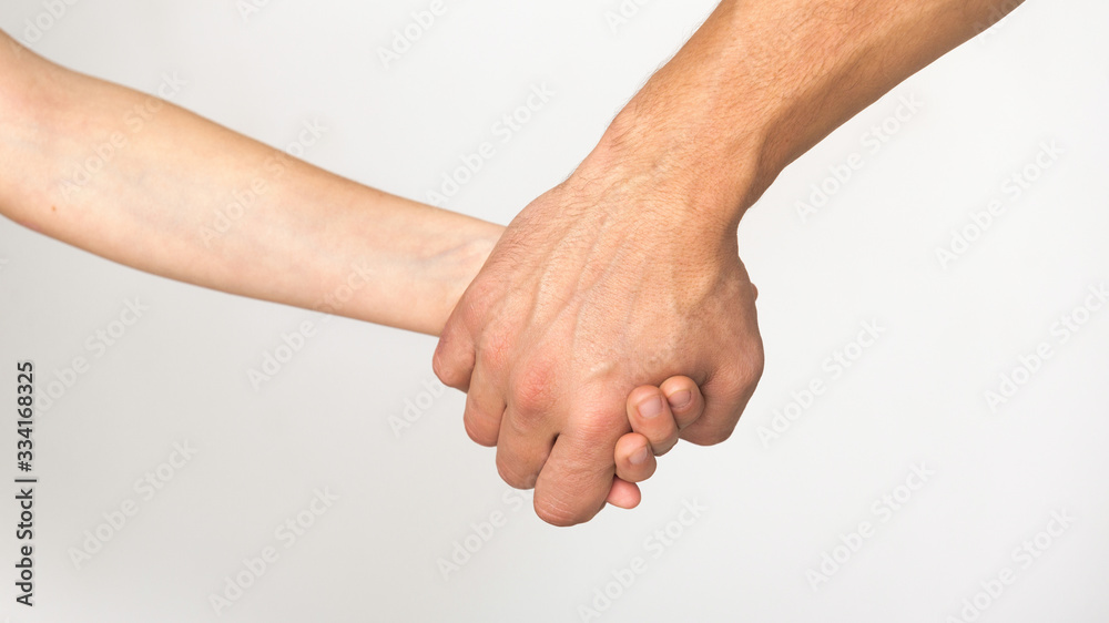 Father and son holding hands, white studio background Father and son holding hands, white studio background