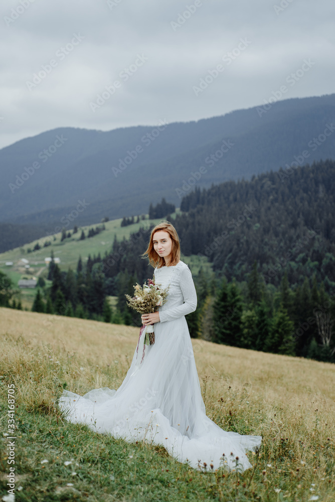 Photoshoot of the bride in the mountains. Boho style wedding photo.