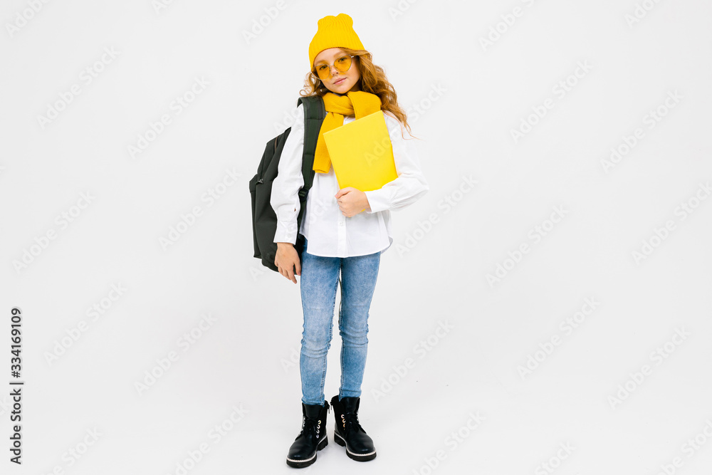 teenager girl with books in hand and a backpack on his shoulders on a white isolated background teenager girl with books in hand and a backpack on his shoulders on a white isolated background