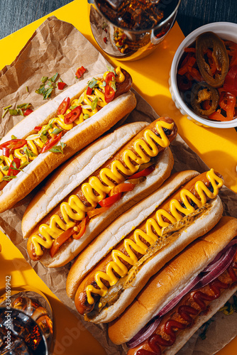 American hot dog with ingredients on a dark wooden background