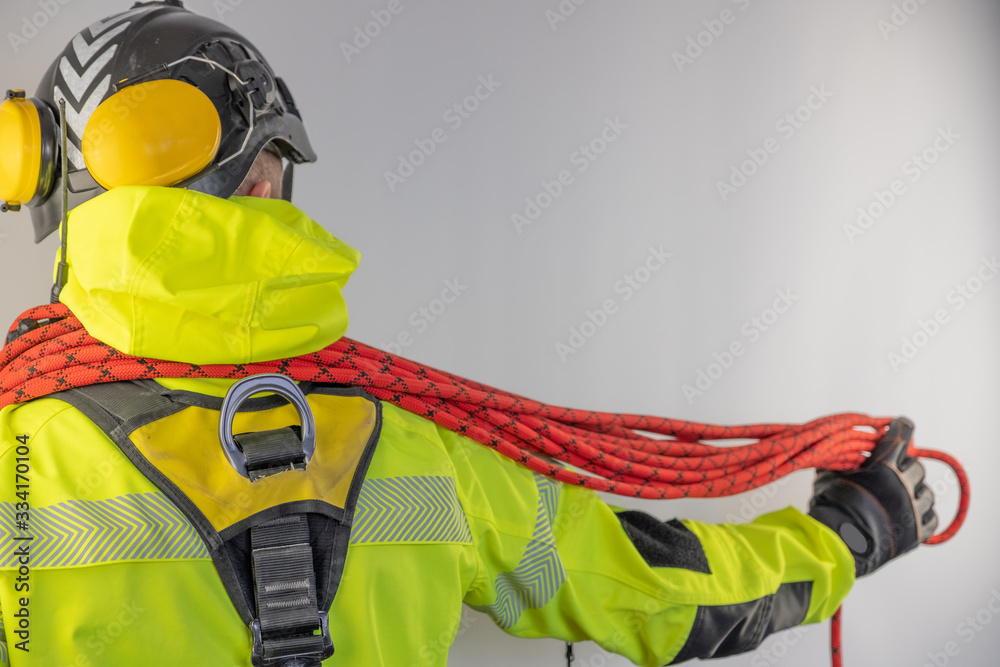 Fototapeta premium Man in personal protective equipment against falling from a height