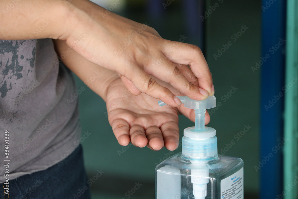 Hands is pressing the pump dispenser from pump bottle of alcohol gel or sanitizer gel for wash the hand, for killing germs and coronavirus. Hands is pressing the pump dispenser from pump bottle of alcohol gel or sanitizer gel for wash the hand, for killing germs and coronavirus.