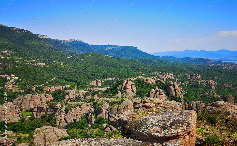 Scenic Bulgarian landscape with mountains and forests as seen from the Belogradchick Rocks, amazing view in the landmark rock formations of Bulgaria