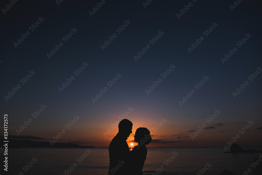 Silhouettes of lovely couple man and woman In beutiful Nature sunset. Couple love concept.