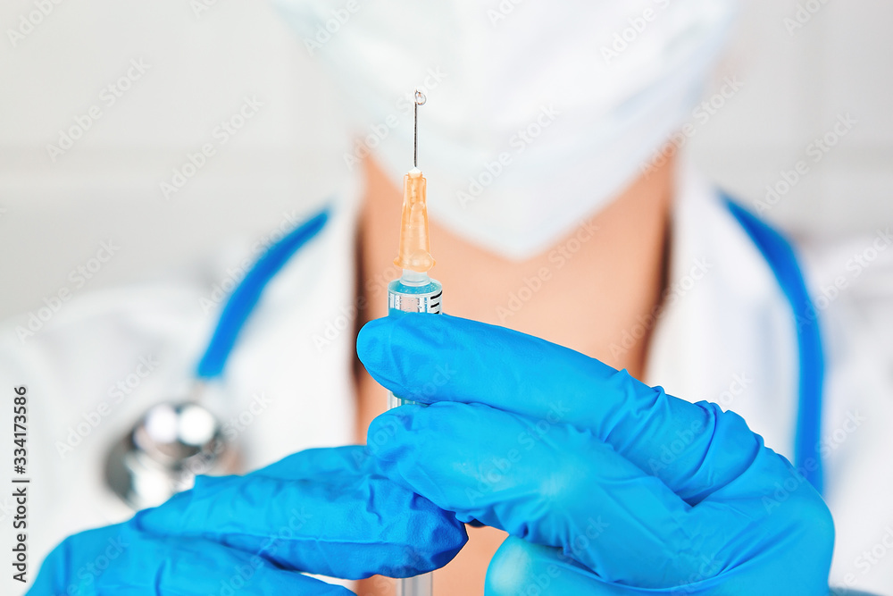 Portrait of a healthcare professional preparing an injection. Vaccine against coronavirus (covid-19) or other disease