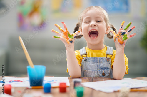 Fototapeta Naklejka Na Ścianę i Meble -  Happy kid is painting at home.