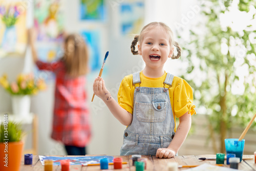 Fototapeta Naklejka Na Ścianę i Meble -  Happy kid is painting at home.