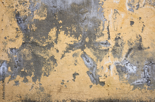 cracked yellow cement wall with hazy fragments, full frame