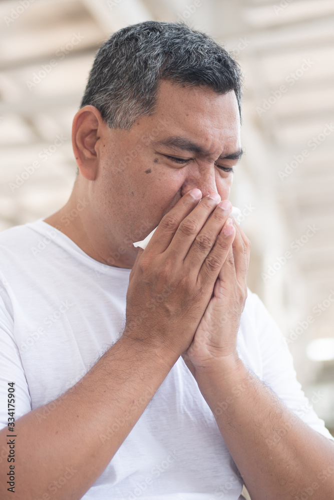 allergic sick old man sneezing flu; concept of man with coronavirus covid-19 infection spreading the disease, allergy, sore throat or lung inflammation, pneumonia, influenza, flu, cold, sickness allergic sick old man sneezing flu; concept of man with coronavirus covid-19 infection spreading the disease, allergy, sore throat or lung inflammation, pneumonia, influenza, flu, cold, sickness