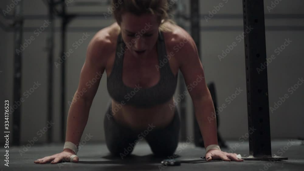 Female Athlete Performing Burpees And Press Ups