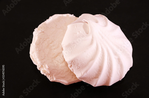 pink marshmallows on a black background. Close-up.