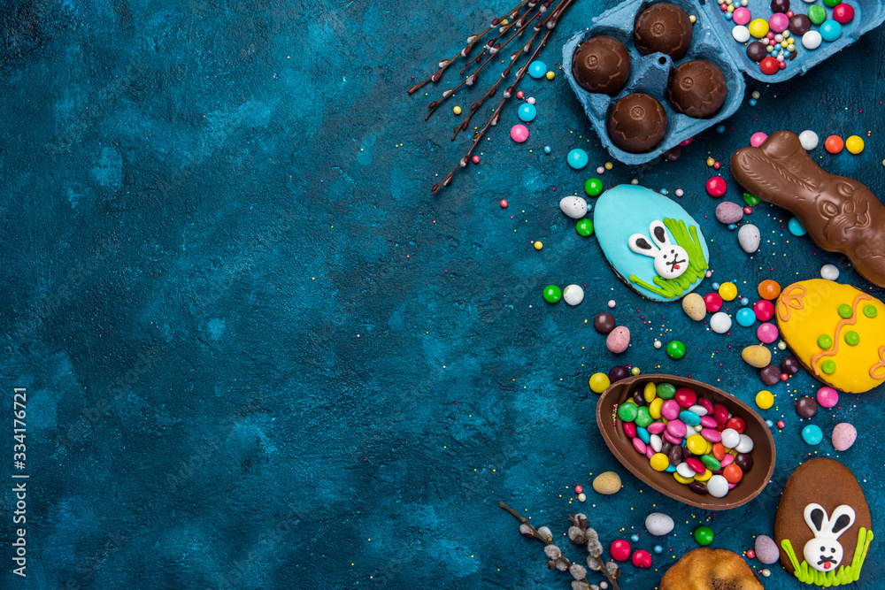 Colorful Easter Festive Background. Sweet Food Candy and Chocolate Eggs and Rabbit