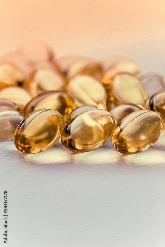 Cod liver oil capsules in a fish shape with copy space. Healthcare concept Cod liver oil capsules in a fish shape with copy space. Healthcare concept