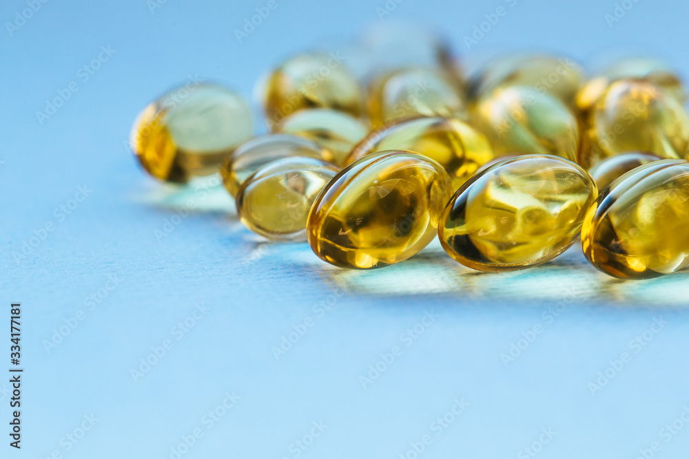 Cod liver oil capsules in a fish shape with copy space. Healthcare concept Cod liver oil capsules in a fish shape with copy space. Healthcare concept