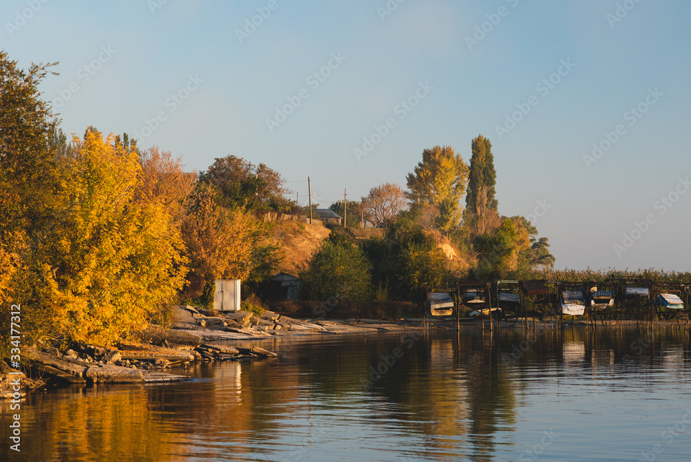 Autumn shore near the water near the boat