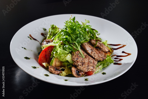 Warm salad with grilled meat and vegetables.