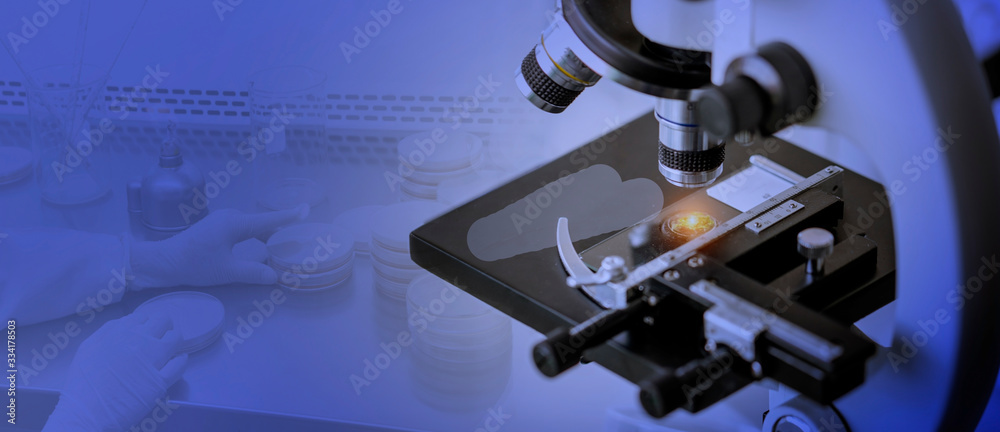 Laboratory concept; Close-up shot of microscope with blurred background of microbiology testing Laboratory concept; Close-up shot of microscope with blurred background of microbiology testing