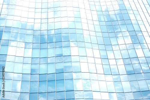 View of the clouds reflected in the curve glass office building.building with copy space