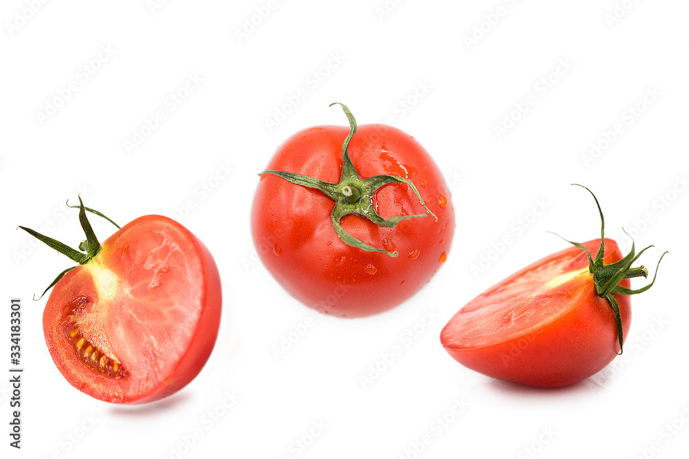 ripe fresh organic tomato and two halves of a tomato in the drops of dew isolated on a white background ripe fresh organic tomato and two halves of a tomato in the drops of dew isolated on a white background
