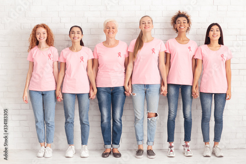 Diverse Breast Cancer Volunteers Ladies Holding Hands Standing Together Indoors