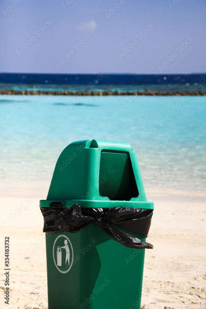 Green Plastic Flap Bin on Clean Sandy Tropical Beach after Recycling Waste Green Plastic Flap Bin on Clean Sandy Tropical Beach after Recycling Waste