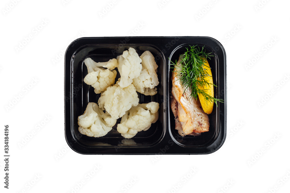 Healthy lunch at workplace. Take away meals in black containers with cutlery on gray table Healthy lunch at workplace. Take away meals in black containers with cutlery on gray table