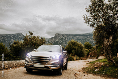 silver car on the road in front of mountains