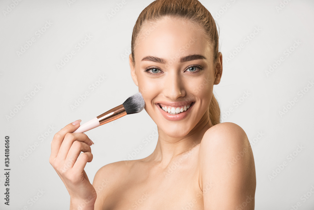 Woman Using Brush Applying Face Powder Posing On Gray Background Woman Using Brush Applying Face Powder Posing On Gray Background