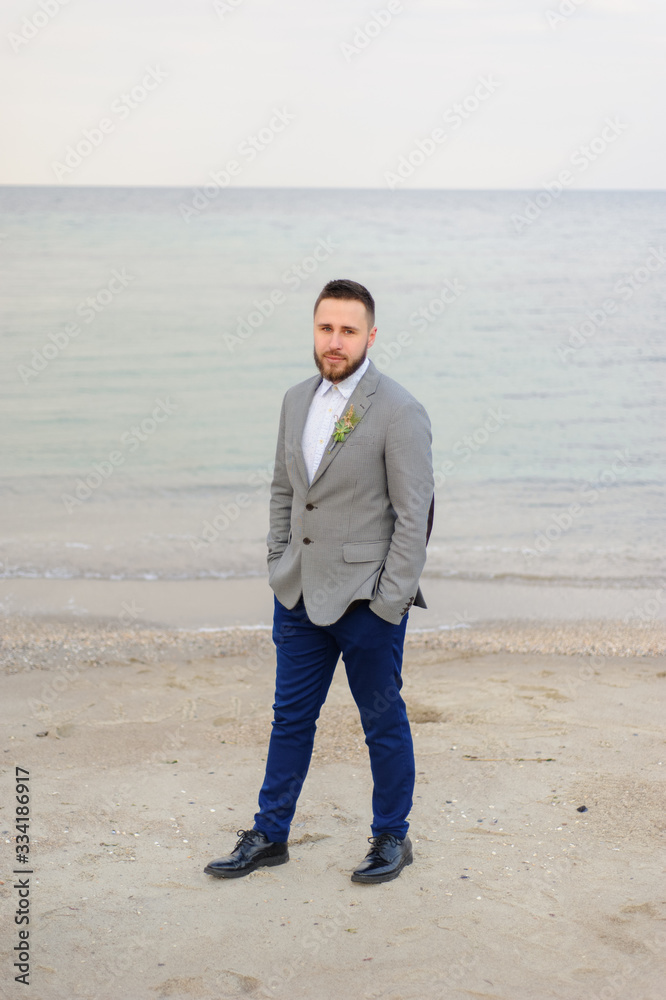 Portrait of the groom. Wedding photo session of a couple on the seashore. Portrait of the groom. Wedding photo session of a couple on the seashore.