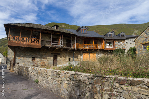 Old rural stone buildings, slate roofs and wooden balconies 