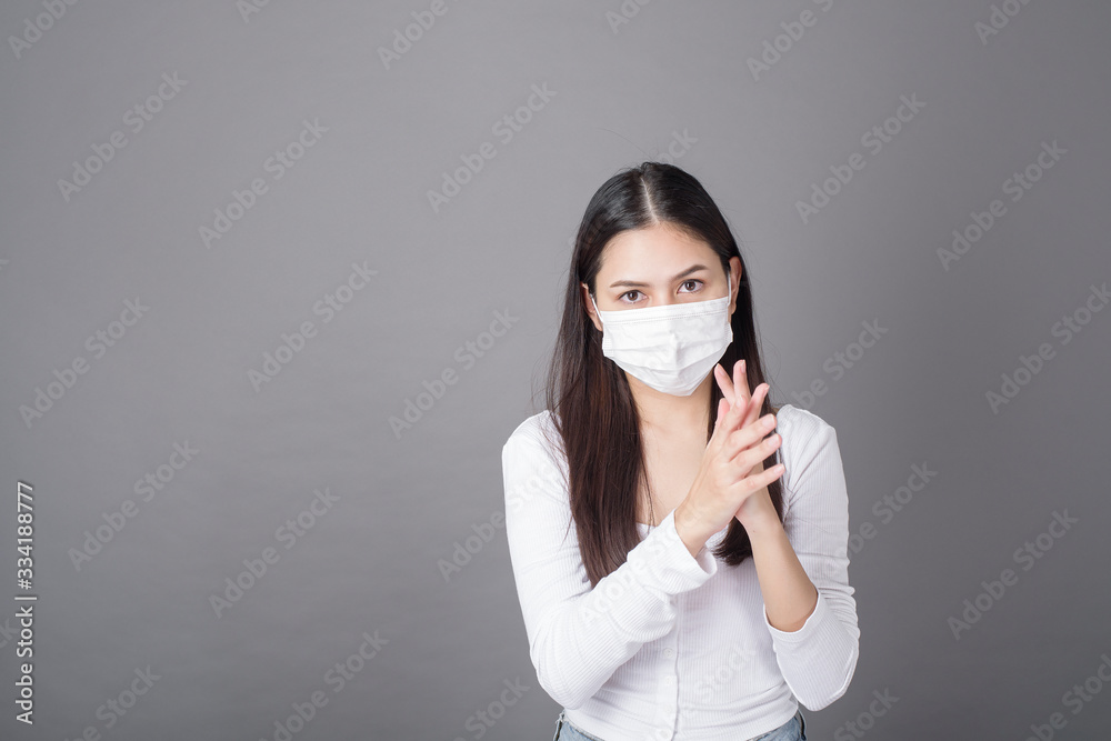 Portrait of woman with surgical mask using alcohol gel sanitizer Portrait of woman with surgical mask using alcohol gel sanitizer