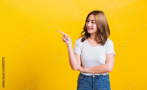 woman teen standing wear t-shirt pointing finger away side